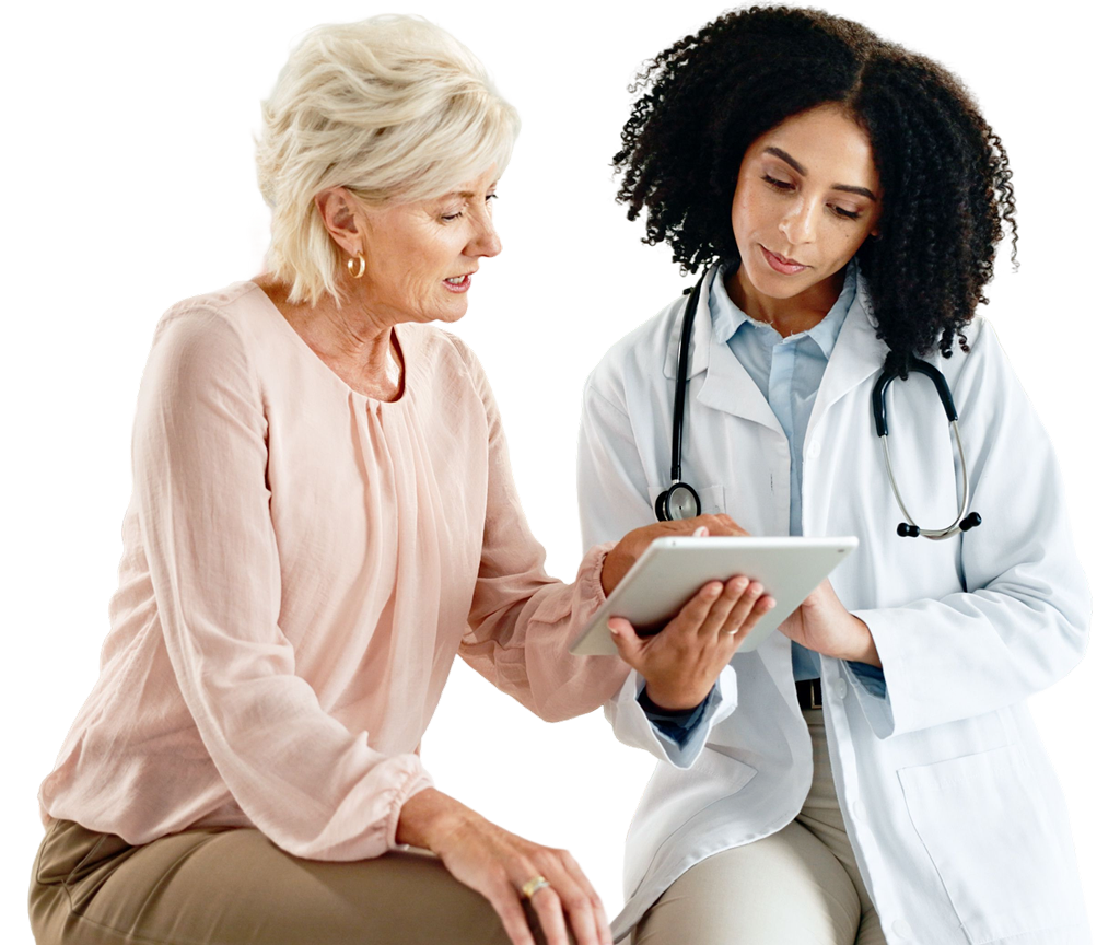 A woman and a doctor sit together against a black background, engaged in conversation.