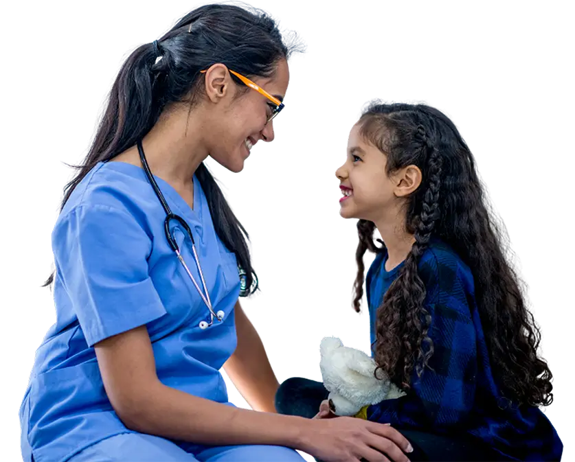 A young girl and a nurse sit together, sharing a moment of care and support in a warm, inviting environment.