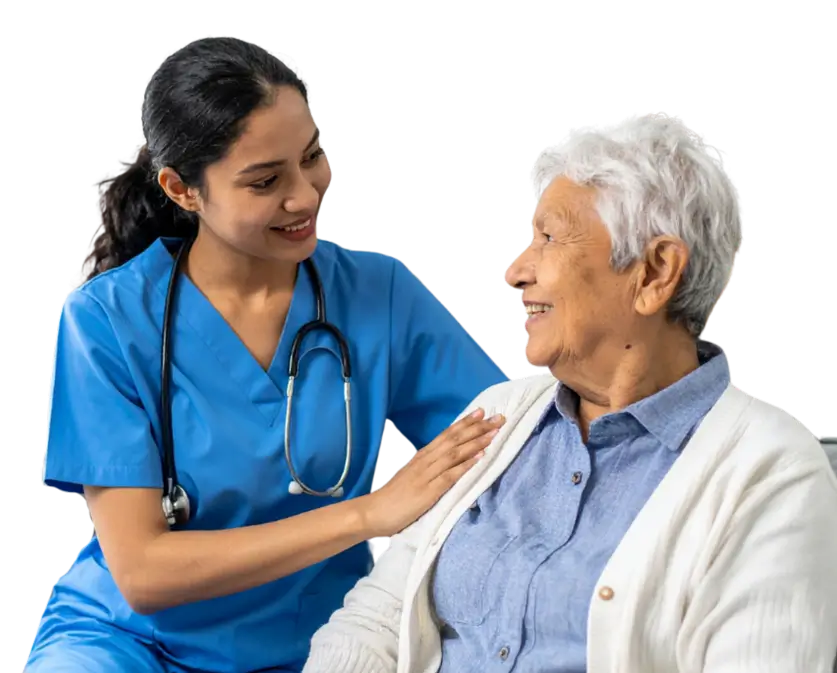 A nurse converses with an elderly woman, providing care and support in a warm, compassionate setting.