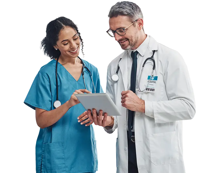 A healthcare professional and a nurse review data on a tablet, collaborating on patient care in a medical environment.
