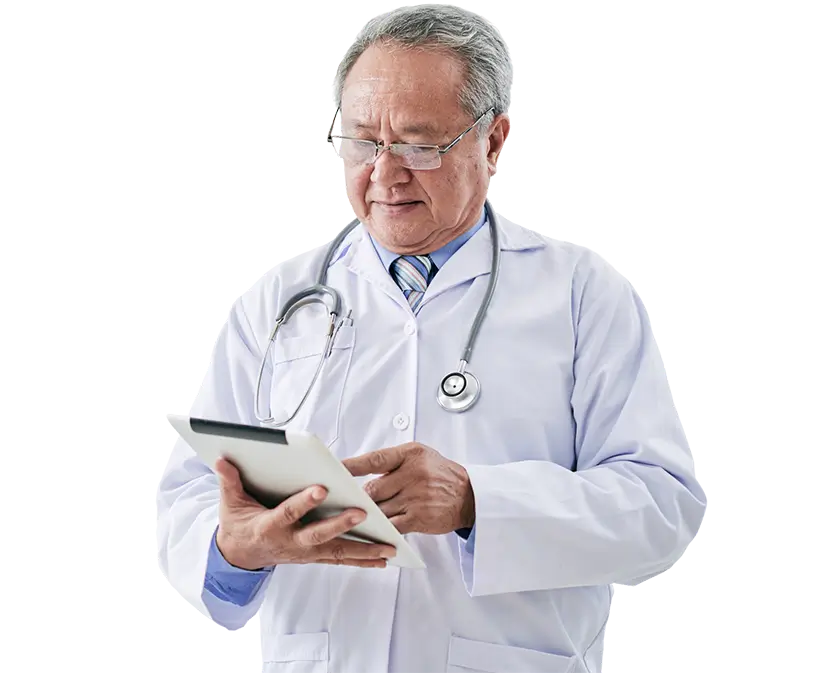 A doctor in a white coat is holding a tablet, looking at the screen with a focused expression.