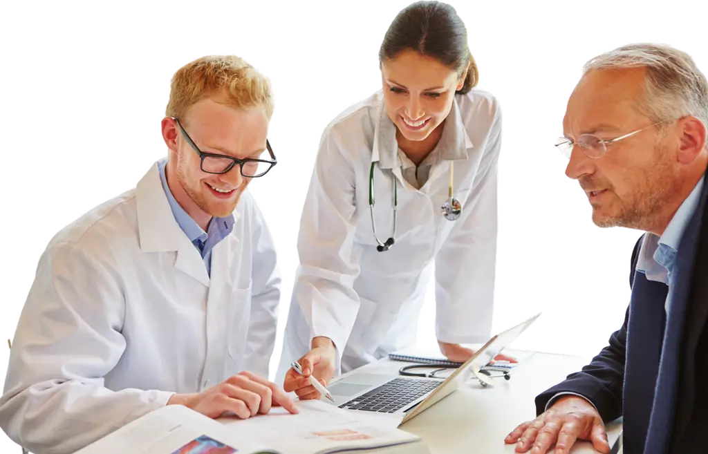 Three doctors discuss treatment options at a table in a clinical setting.